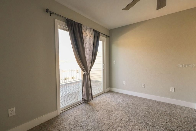 spare room with carpet floors and ceiling fan