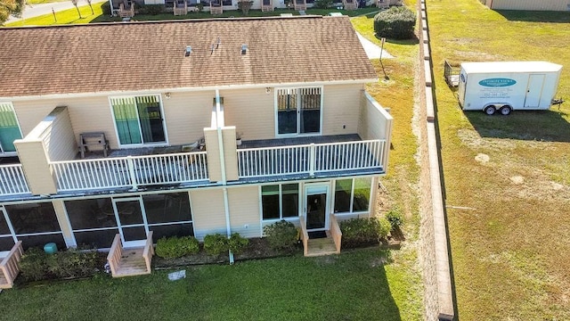 rear view of property featuring a balcony