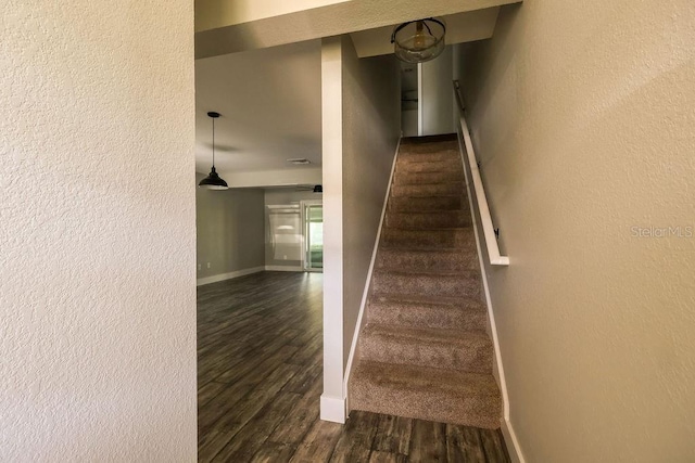 staircase with hardwood / wood-style floors