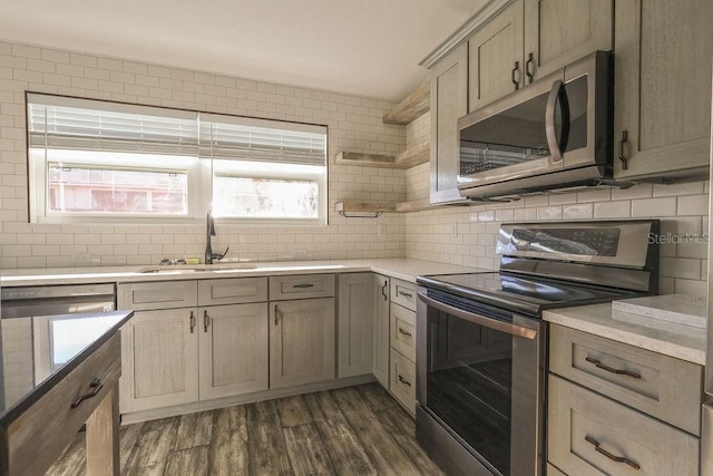 kitchen featuring tasteful backsplash, sink, stainless steel appliances, dark wood-type flooring, and light brown cabinets