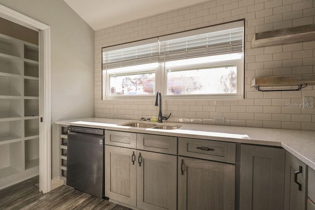 kitchen featuring tasteful backsplash, a healthy amount of sunlight, black dishwasher, and sink