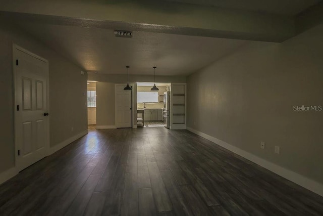 unfurnished living room with dark hardwood / wood-style flooring