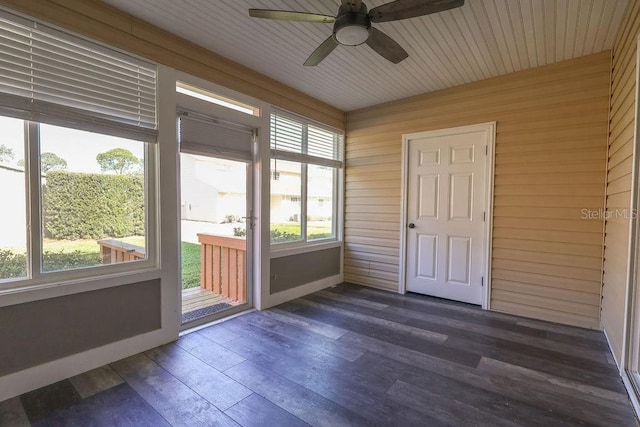 unfurnished sunroom with ceiling fan