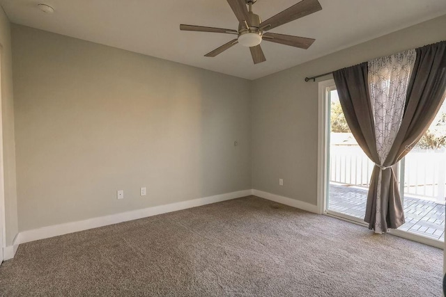 spare room with ceiling fan and carpet