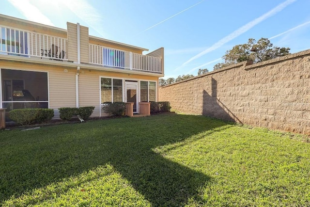 view of yard featuring a balcony