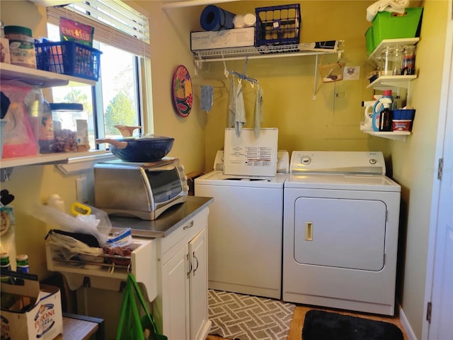 laundry area featuring cabinets and independent washer and dryer