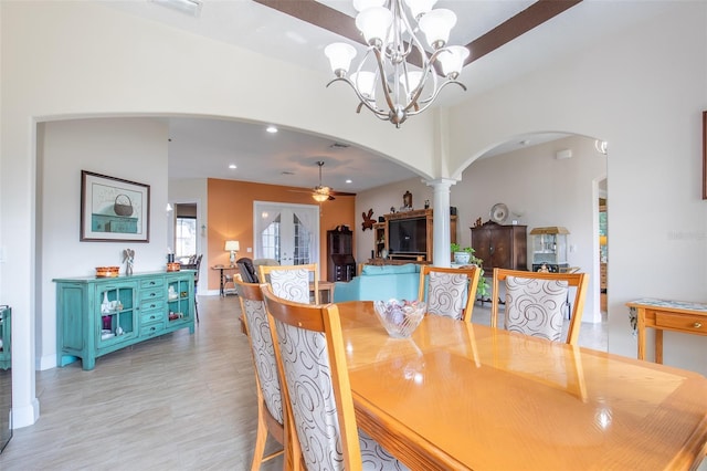 dining space with arched walkways, recessed lighting, visible vents, ornate columns, and ceiling fan with notable chandelier