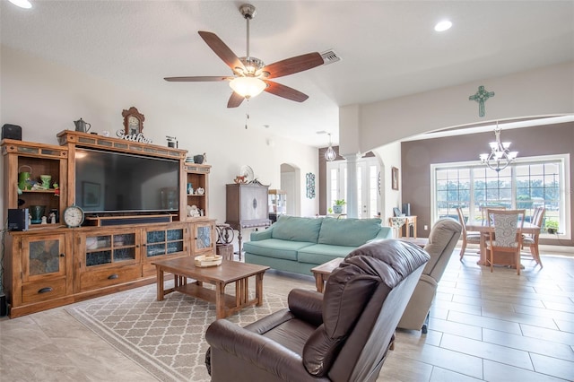 living room featuring arched walkways, light tile patterned floors, recessed lighting, ceiling fan with notable chandelier, and visible vents