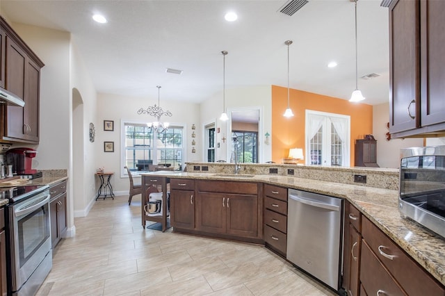 kitchen with stainless steel appliances, a sink, visible vents, dark brown cabinets, and light stone countertops