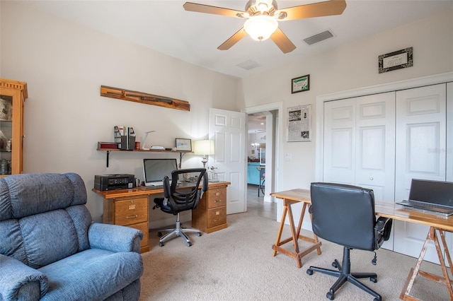 office space with light colored carpet, visible vents, and ceiling fan