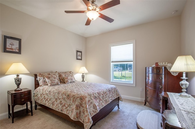 bedroom with a ceiling fan, carpet, and baseboards