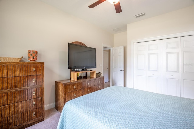 bedroom featuring ceiling fan, visible vents, baseboards, a closet, and carpet