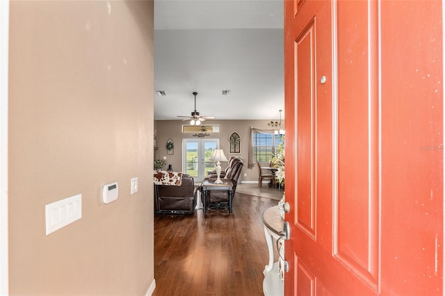 foyer entrance featuring ceiling fan, french doors, and dark wood-type flooring