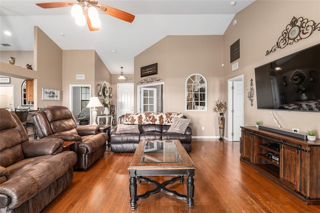 living room featuring hardwood / wood-style floors, high vaulted ceiling, and ceiling fan