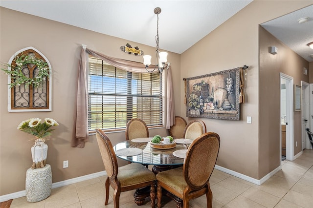 dining area featuring a chandelier, light tile patterned floors, and vaulted ceiling