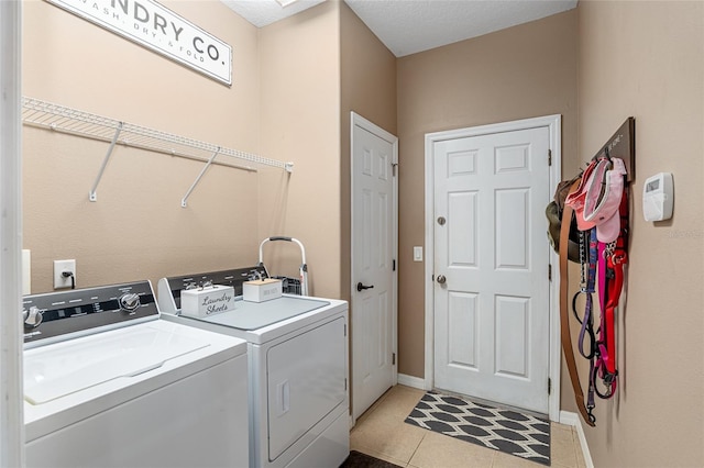 laundry room featuring light tile patterned flooring and washer and dryer