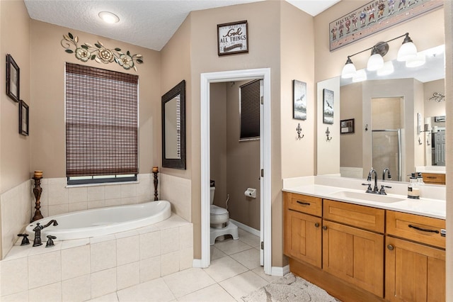 full bathroom featuring vanity, a textured ceiling, independent shower and bath, tile patterned flooring, and toilet