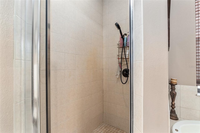 bathroom with a shower with door