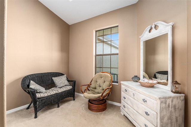 living area with light colored carpet and vaulted ceiling