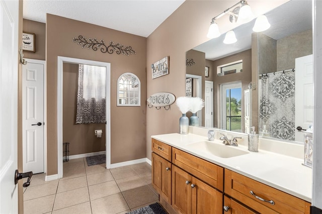 bathroom with tile patterned floors, vanity, and a shower with shower curtain