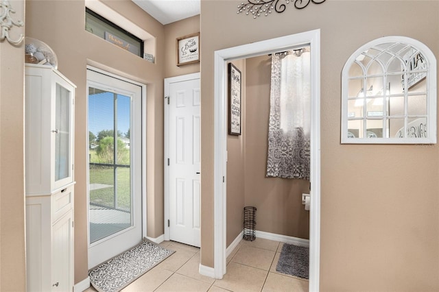 doorway to outside featuring light tile patterned flooring