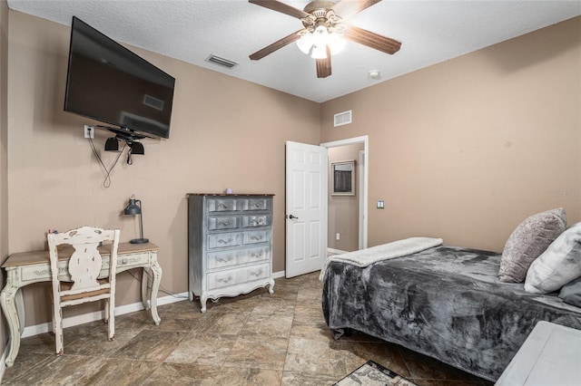 bedroom with a textured ceiling and ceiling fan