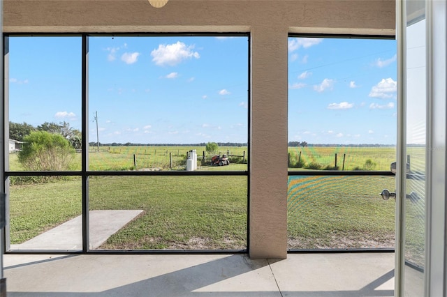 entryway featuring plenty of natural light and a rural view