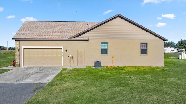 view of side of home featuring a lawn and a garage