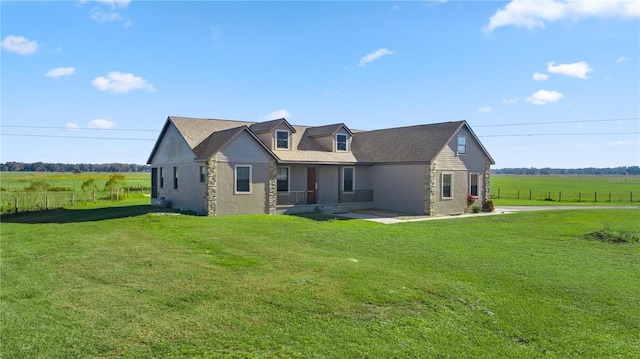 view of front of home with a front lawn and a rural view