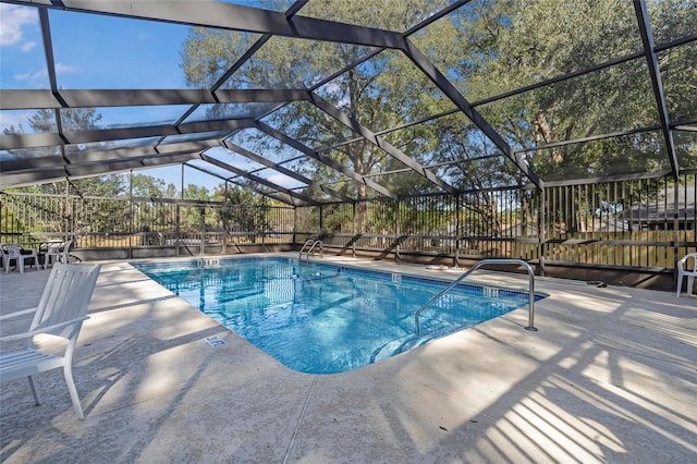 view of swimming pool with a lanai and a patio area