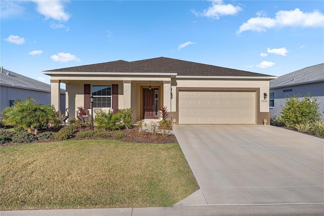 ranch-style house featuring a garage and a front lawn