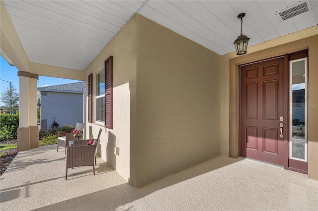 doorway to property featuring a porch