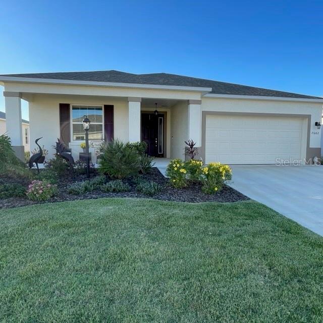 view of front of property with a garage and a front lawn