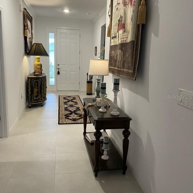 hallway featuring light tile patterned floors