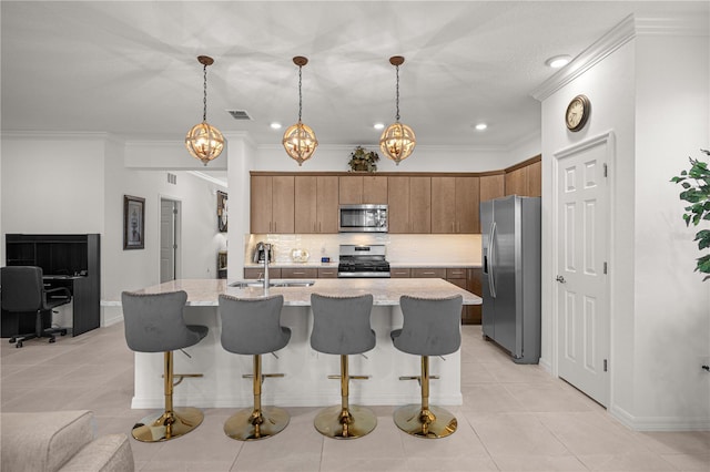 kitchen with sink, stainless steel appliances, a kitchen breakfast bar, decorative light fixtures, and light tile patterned floors