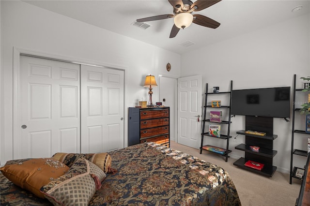 carpeted bedroom featuring ceiling fan and a closet