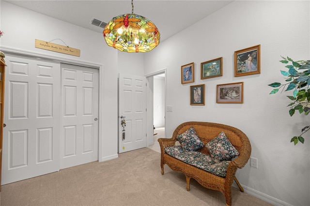 living area featuring light colored carpet