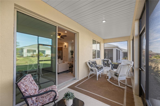 sunroom featuring ceiling fan and wooden ceiling