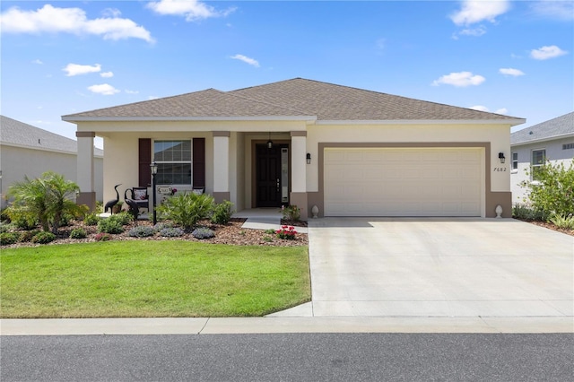 view of front of house featuring a garage, stucco siding, and a front yard