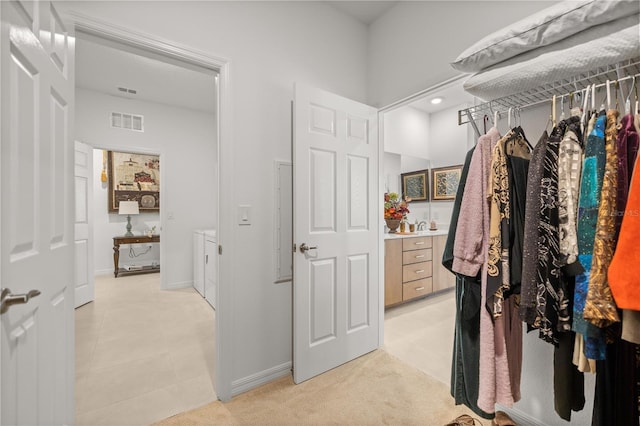 spacious closet featuring visible vents and washer and clothes dryer