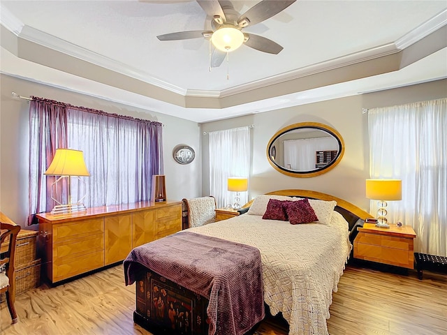 bedroom with ceiling fan, crown molding, and multiple windows