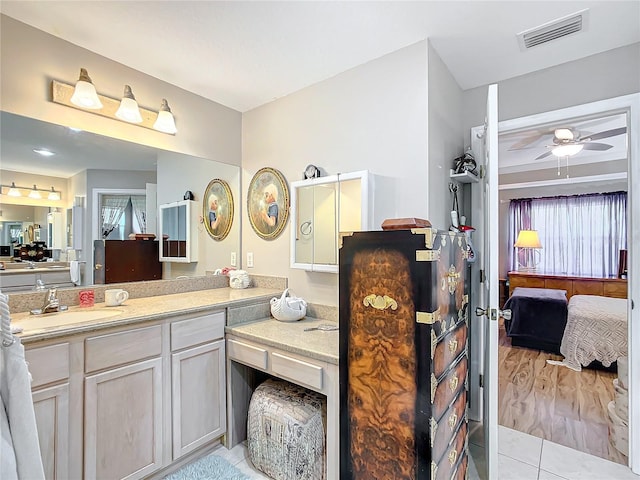 bathroom with tile patterned flooring, vanity, and ceiling fan