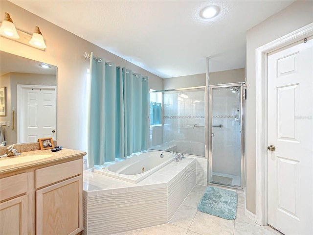 bathroom featuring plus walk in shower, vanity, and tile patterned flooring