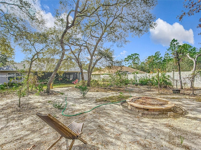 view of yard featuring an outdoor fire pit