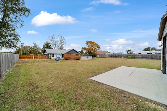 view of yard with a deck and a patio