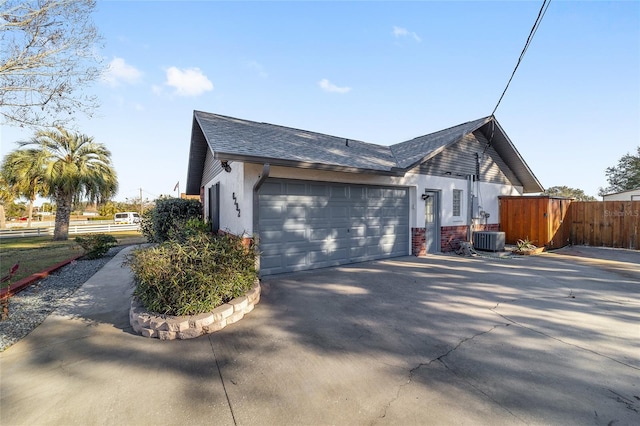 view of home's exterior featuring a garage and central AC unit