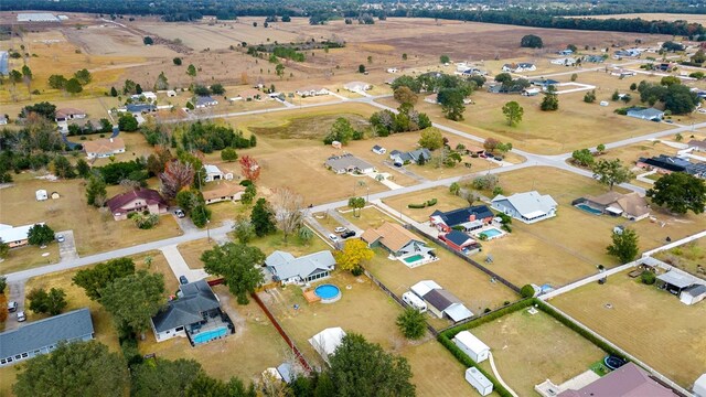 birds eye view of property with a rural view