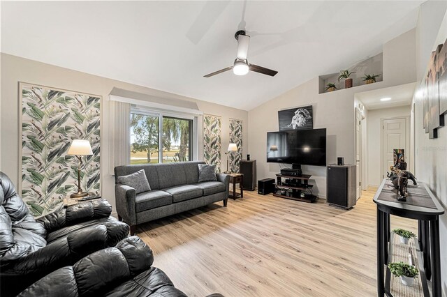 living room featuring vaulted ceiling, ceiling fan, and light hardwood / wood-style floors