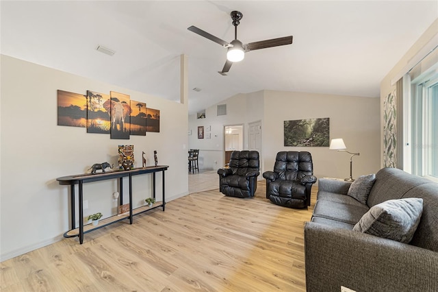 living room with ceiling fan, lofted ceiling, and light hardwood / wood-style flooring