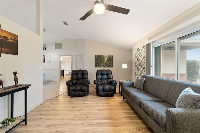 living room featuring ceiling fan, light wood-type flooring, and vaulted ceiling